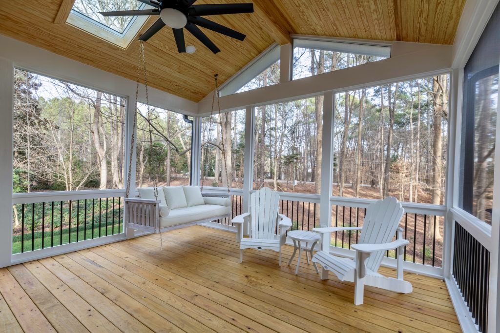 Screened porch with vaulted ceiling, skylights and bed swing